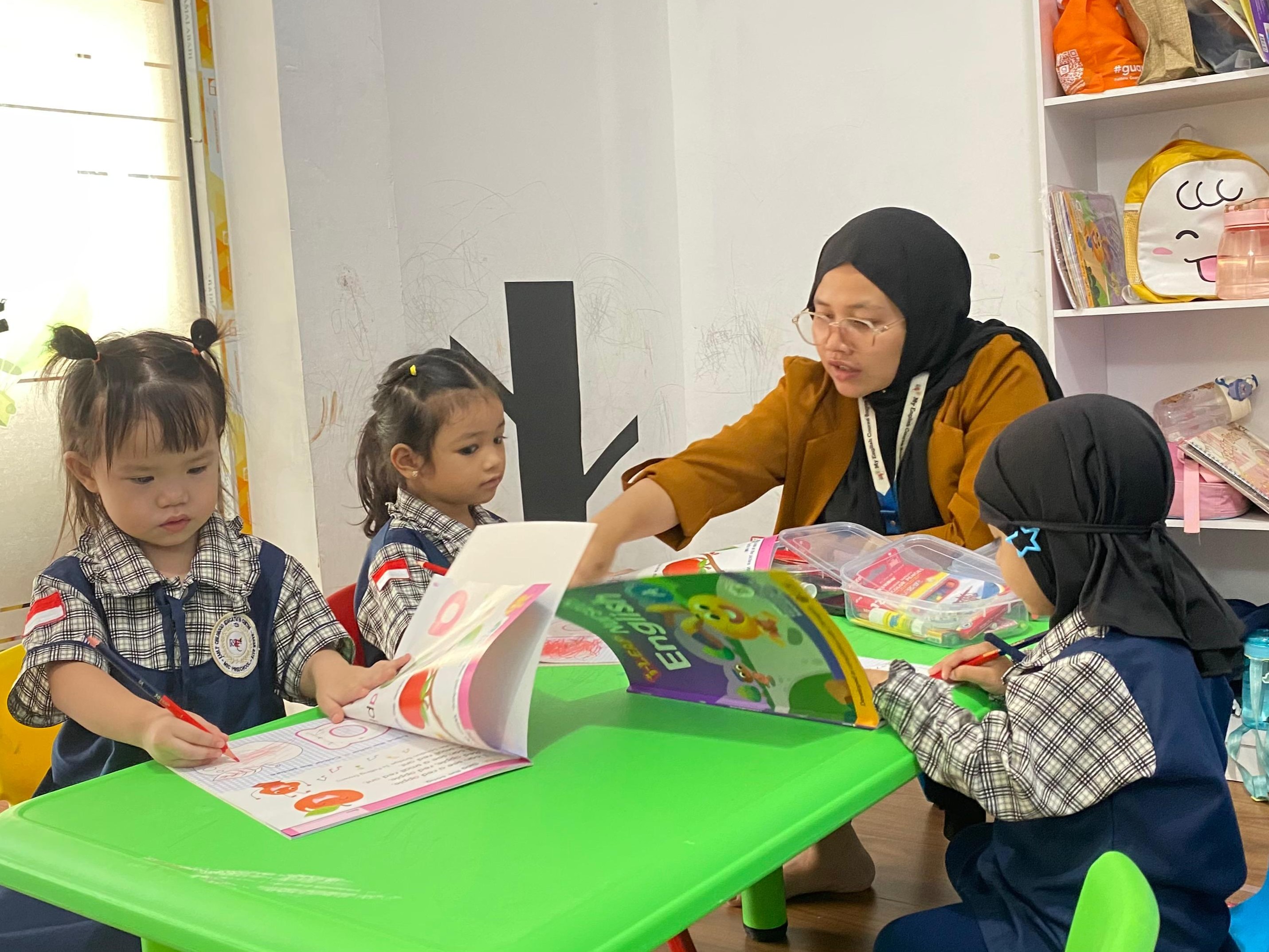 MEC Preschool teacher reading a storybook to children