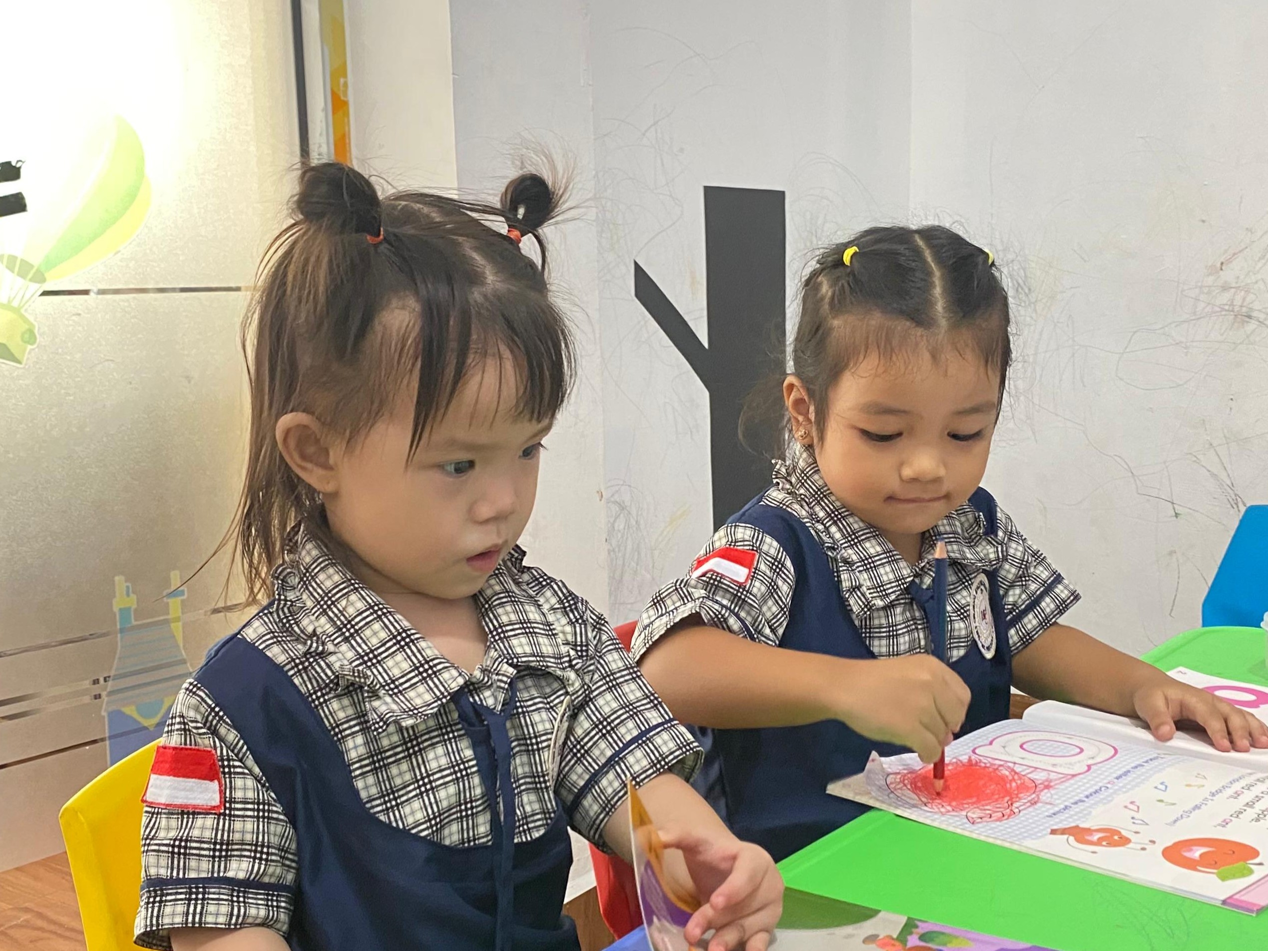 Toddlers playing with colorful blocks in MEC Nursery class