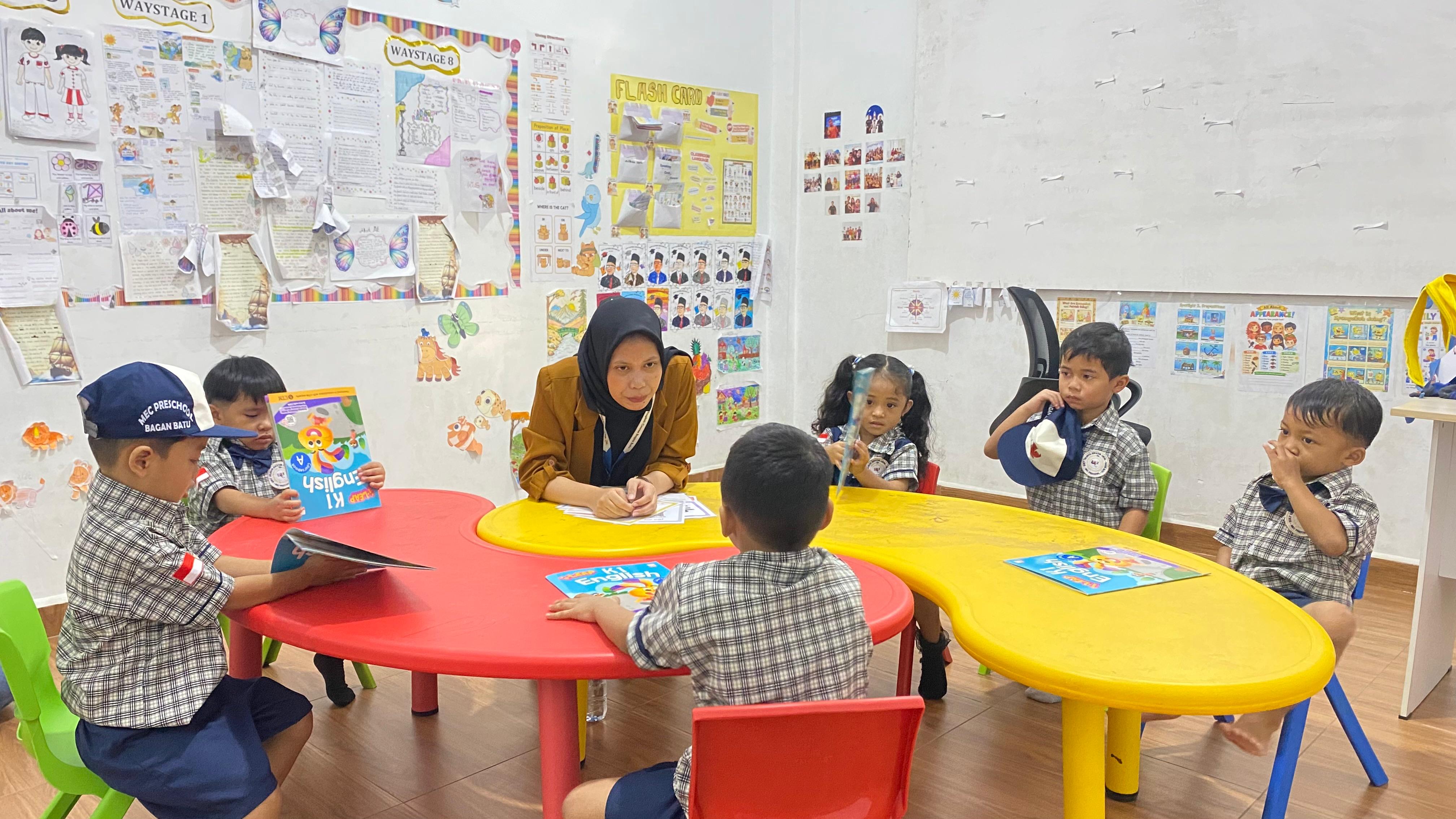 MEC Preschool children taking a group photo while hugging